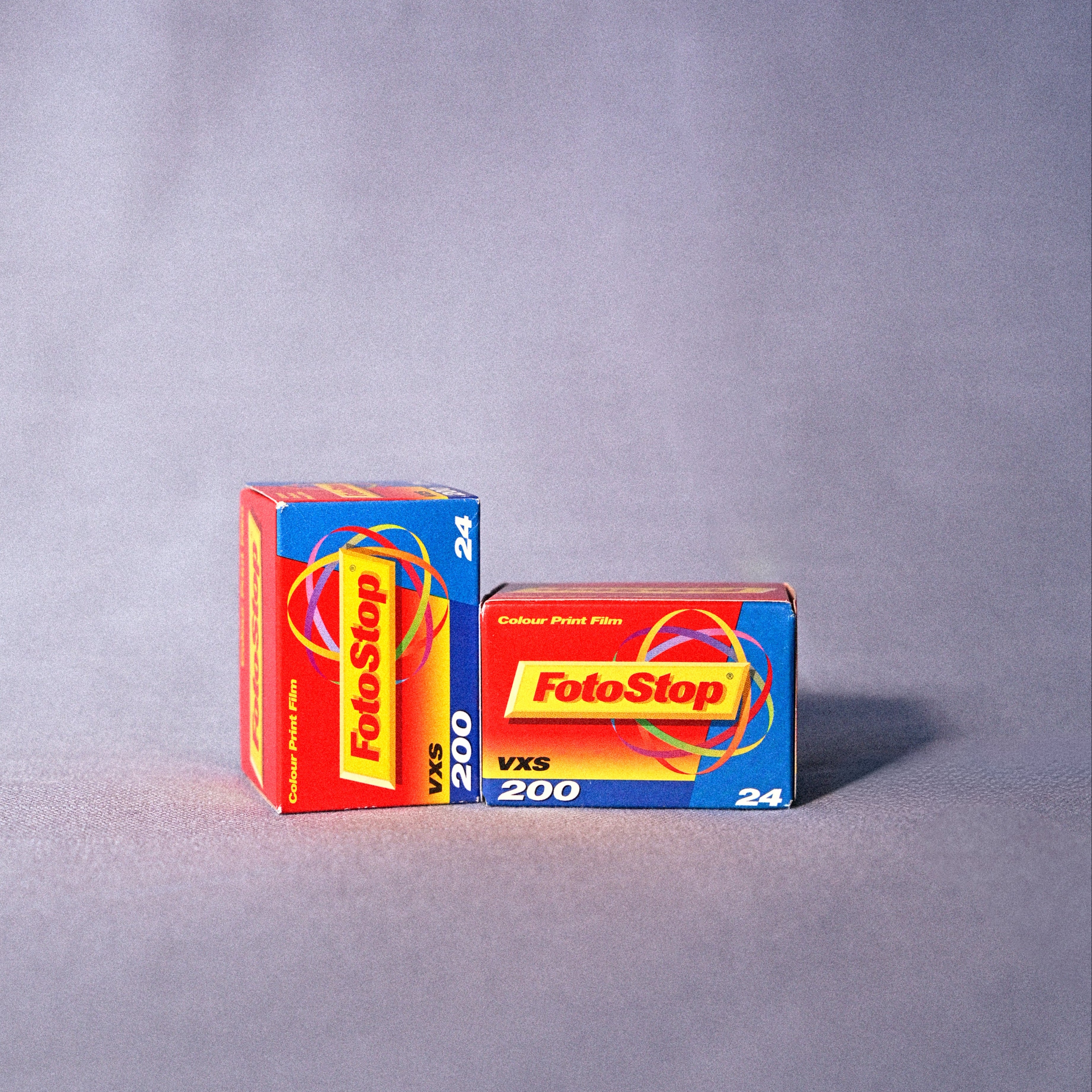 Two boxes of FotoStop 200 film on a gray background