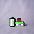 Two rolls of Fujifilm 200 film on a gray background