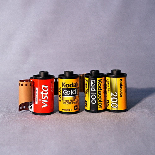 Collection of Kodak film rolls on a gray background