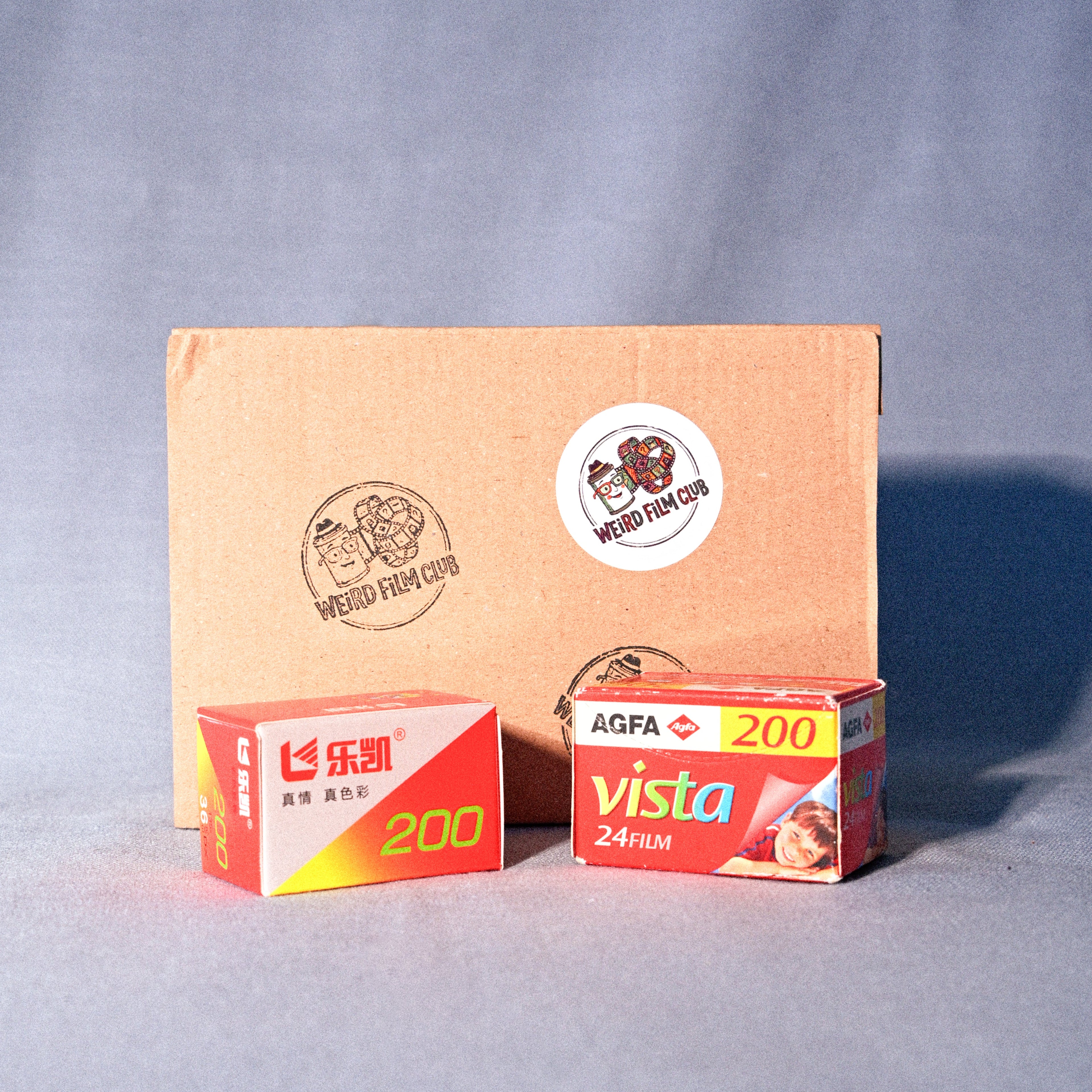 Two vintage camera film boxes on a gray background