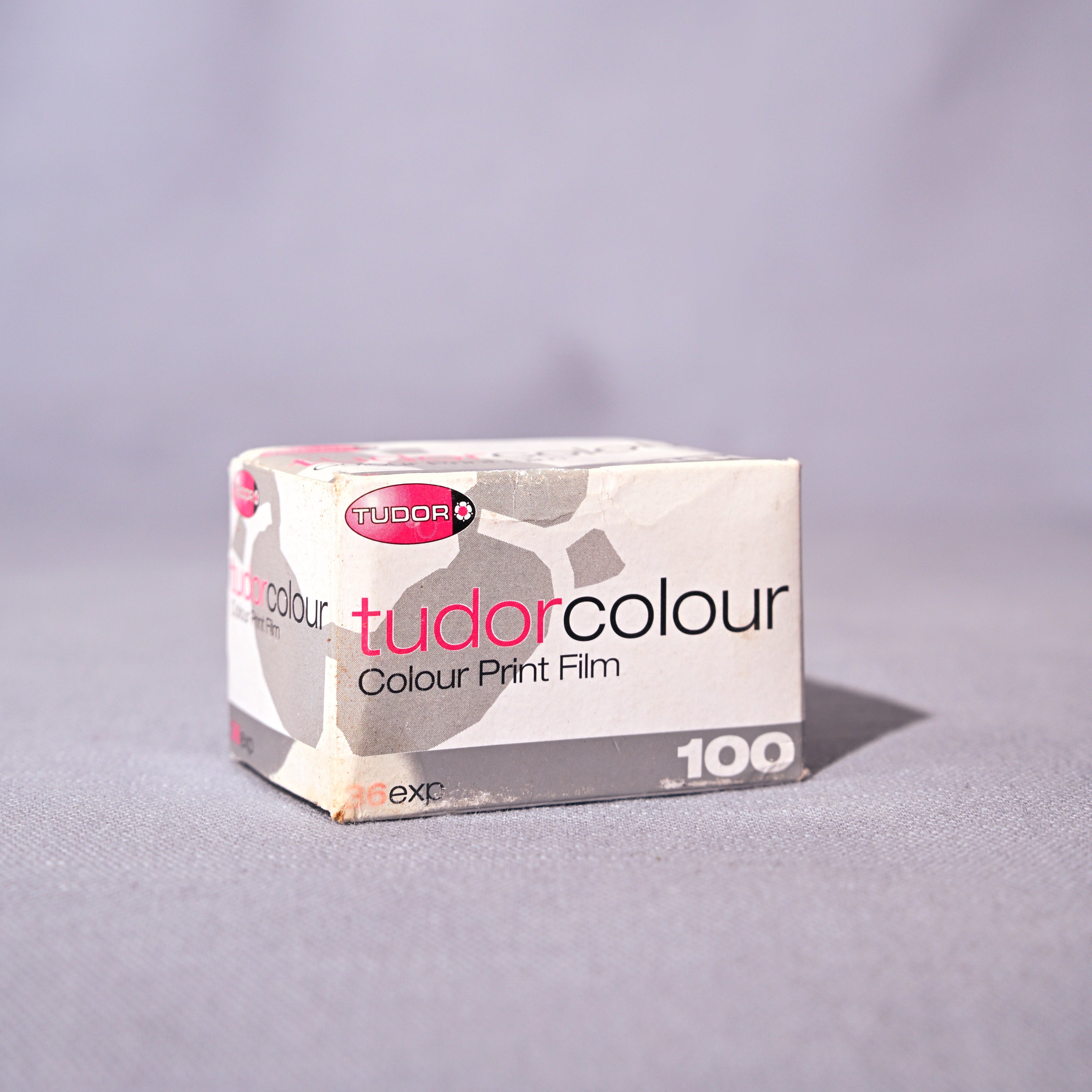 Box of tudor colour color print film on a gray background