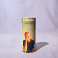 A single roll of doublefilm Apollo 200 color negative film stands upright on a light textured fabric surface against a draped light gray background.