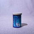 A single canister of Plexus 400 film positioned on a light gray textured surface against a matching light gray fabric backdrop.